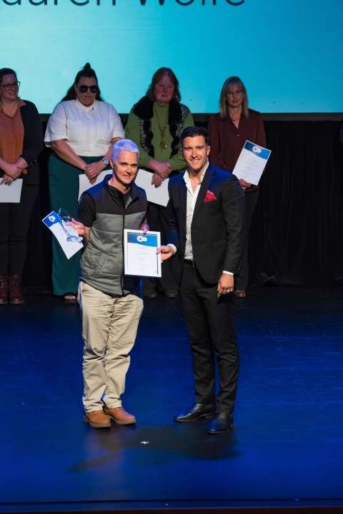 Lauren Wolfe's father accepted the Adult Volunteer Award on her behalf.
